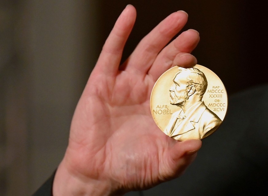FILE - A Nobel medal is held up during a ceremony in New York, Dec. 8, 2020. (Angela Weiss/Pool Photo via AP, File)
Nobel Prize