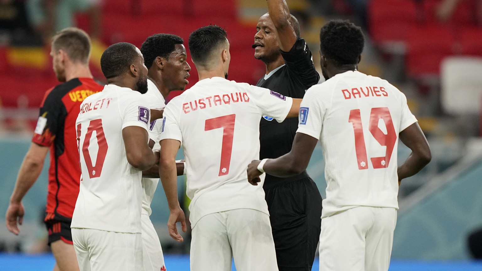 Referee gestures with Canada players during the World Cup group F soccer match between Belgium and Canada, at the Ahmad Bin Ali Stadium in Doha, Qatar, Wednesday, Nov. 23, 2022. (AP Photo/Martin Meiss ...