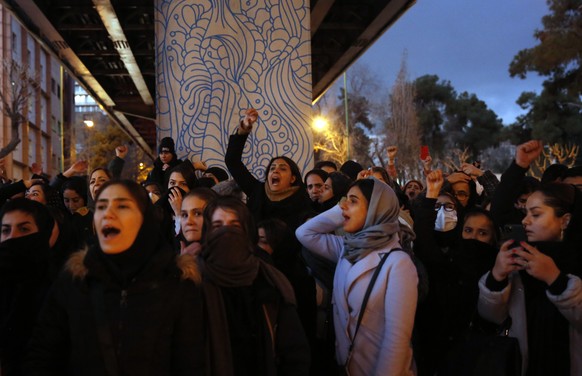 epa08120575 Iranians protest to show their sympathy to victims of Ukraine International Airlines Boeing 737-800 in front of the Amir Kabir University in Tehran, Iran, 11 January 2020. The Iranian mili ...