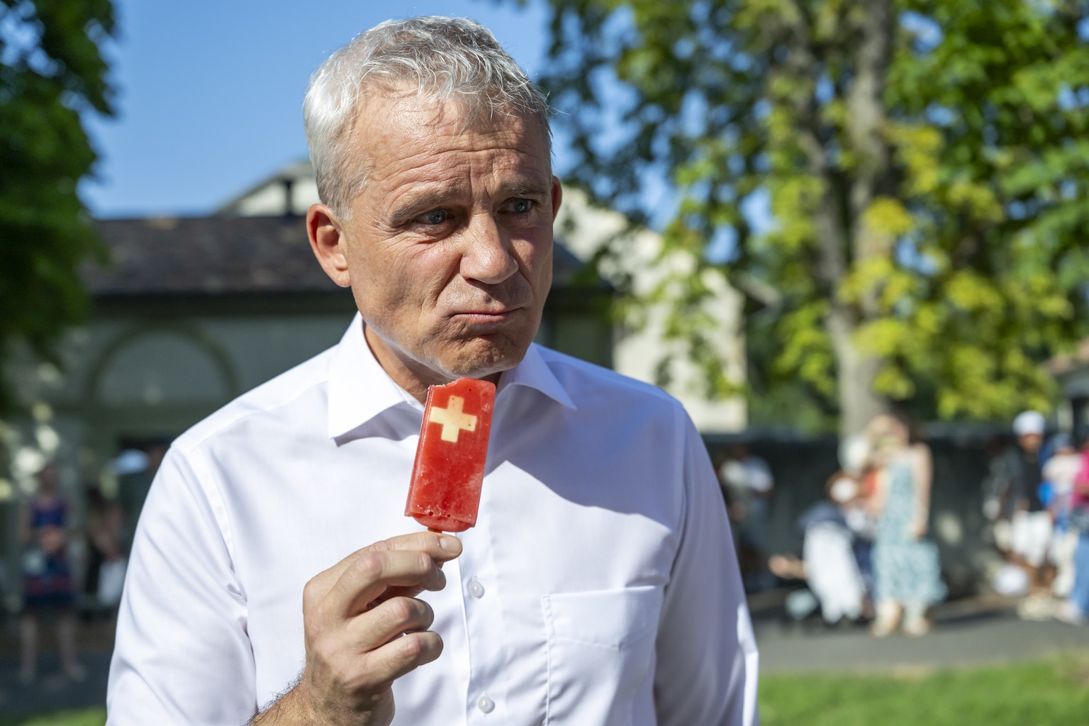Le Conseiller federal Beat Jans, chef du Departement federal de justice et police, mange une glace au couleur de la suisse a l'occasion des celebrations de la fete nationale suisse avec les habit ...