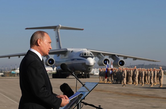 FILE - In this Dec. 12, 2017, file photo, Russian President Vladimir Putin addresses the troops at the Hemeimeem air base in Syria. In an interview on Russian state television, Putin, ahead of his Jun ...