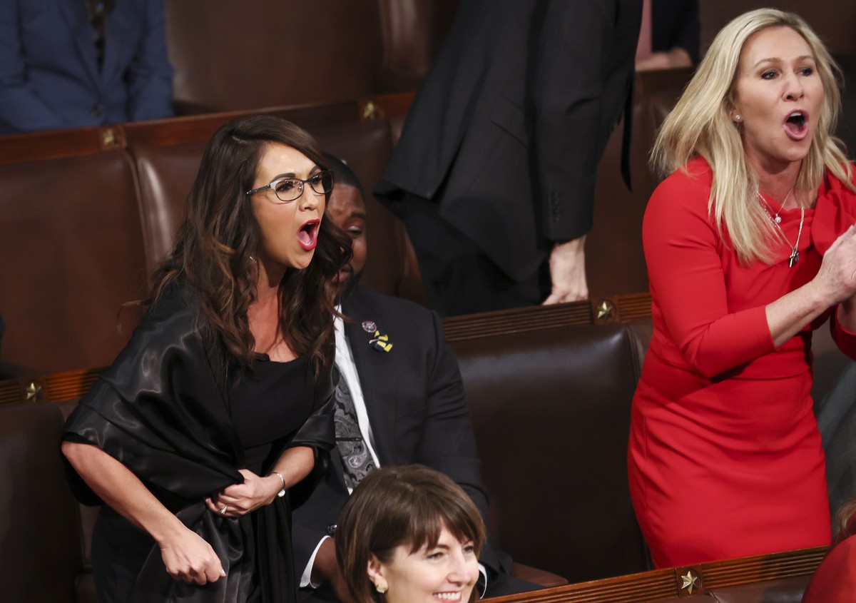 epa09795437 US Rep. Lauren Boebert (R-CO) and Rep. Marjorie Taylor Greene (R-GA) scream "Build the Wall" at President Joe Biden during Biden's State of the Union address to a joint sess ...