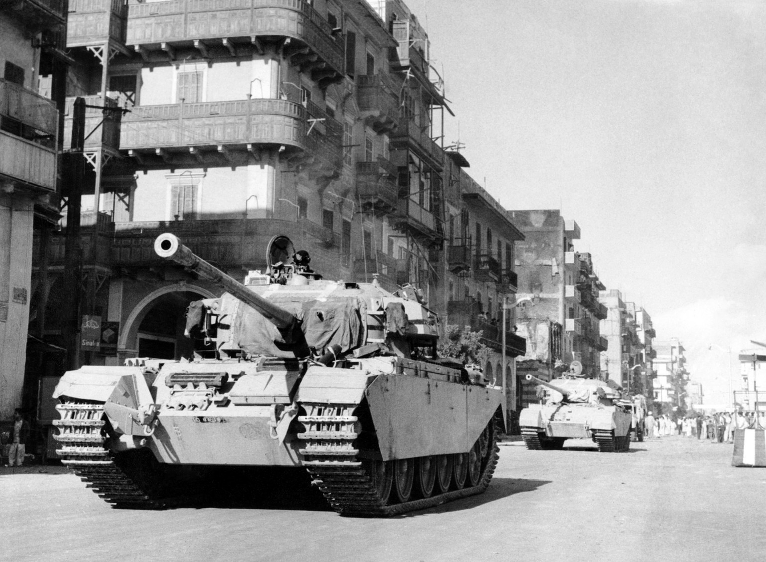 Two British tanks patrolling a street in Port Said, Egypt, on November 8, 1956. (AP Photo)