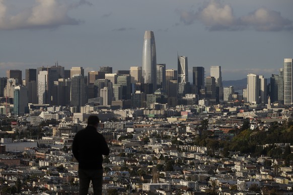 FILE - In this March 16, 2020, file photo, a person looks toward the skyline from Bernal Heights Hill in San Francisco. According to new data from the U.S. Census Bureau released Thursday, Aug. 12, 20 ...