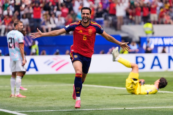 Spain's Mikel Merino (6) celebrates scoring their second goal in front of Belgium's Timothy Castagne (21) and goalkeeper Senne Lammens (12) during the World Cup quarterfinal soccer match bet ...