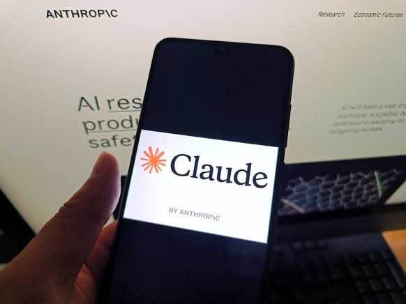 Claude by Anthropic SUQIAN, CHINA - MAY 6, 2026 - A netizen is checking the Claude by Anthropic logo on his mobile phone and the Claude by Anthropic webpage on his computer in Suqian City, Jiangsu Pro ...