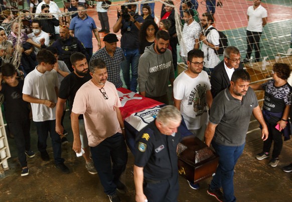 People carry the coffin of Marcelo Arruda, a local official from the leftist Workers&#039; Party, away from the Sebastiao Flores gymnasium to bury him at the Jardim Sao Paulo cemetery in Foz do Iguacu ...