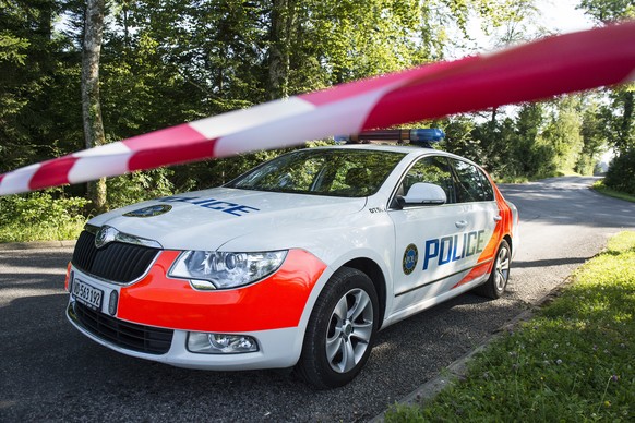 Une voiture de police sert de barrage routier pres du lieu ou sont decedes deux personnes suite a un enlevement ce vendredi 18 juillet 2014 sur la route de la claie aux Moines a Lutry pres de Savigny  ...