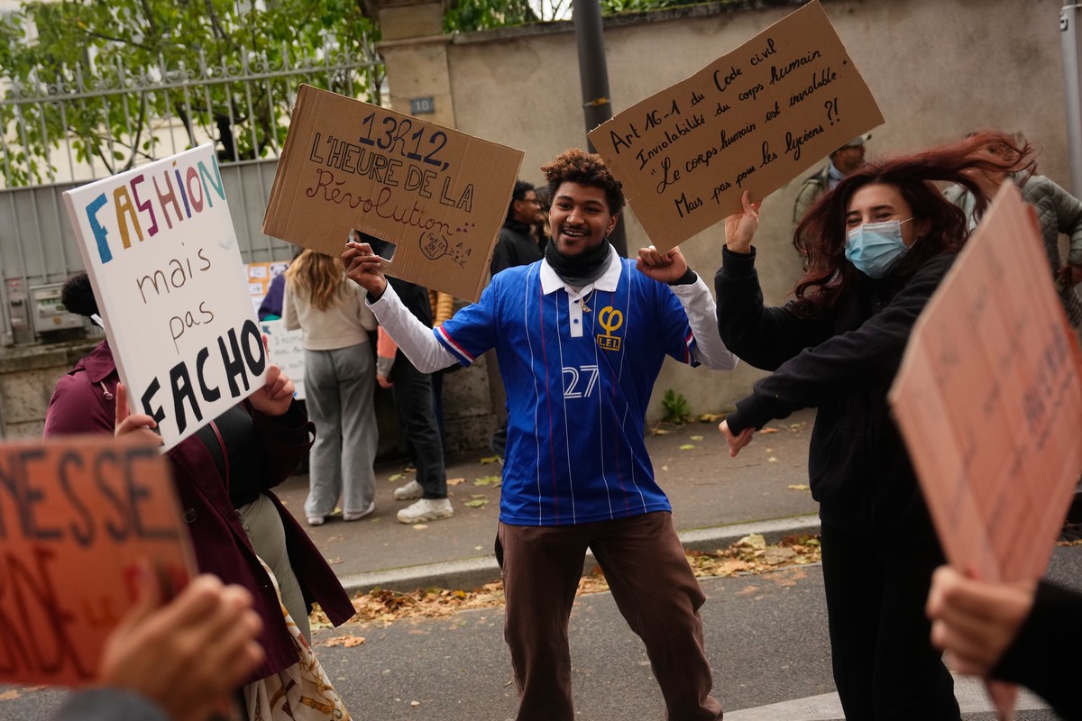 Protesters hold signs reading Fashion but not fascist and Time for revolution during a protest on the sidelines of the far-right Rassemblement National (RN) Congress in Orléans, France, Saturday,  ...
