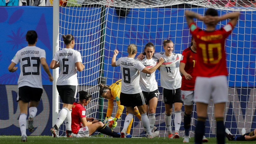 Germany players celebrate after teammate Sara Daebritz, second right, scored the opening goal during the Women&#039;s World Cup Group B soccer match between Spain and Germany at Stade du Hainau in Val ...