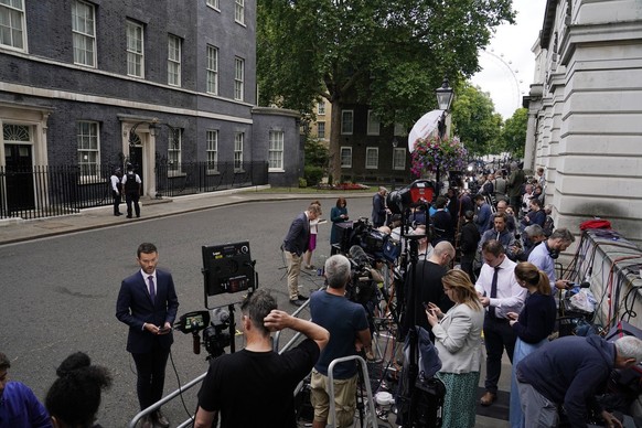Media gather near 10 Downing Street in London, Thursday, July 7, 2022. Prime Minister Boris Johnson has agreed to resign, his office said Thursday, ending an unprecedented political crisis over his future that has paralyzed Britain's government. An official in Johnson's Downing Street office confirmed the prime minister would announce his resignation later. The official spoke on condition of anonymity because the announcement had not yet been made. (AP Photo/Alberto Pezzali)