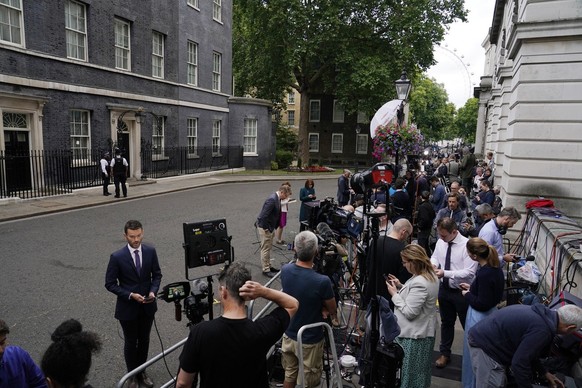 Media gather near 10 Downing Street in London, Thursday, July 7, 2022. Prime Minister Boris Johnson has agreed to resign, his office said Thursday, ending an unprecedented political crisis over his fu ...