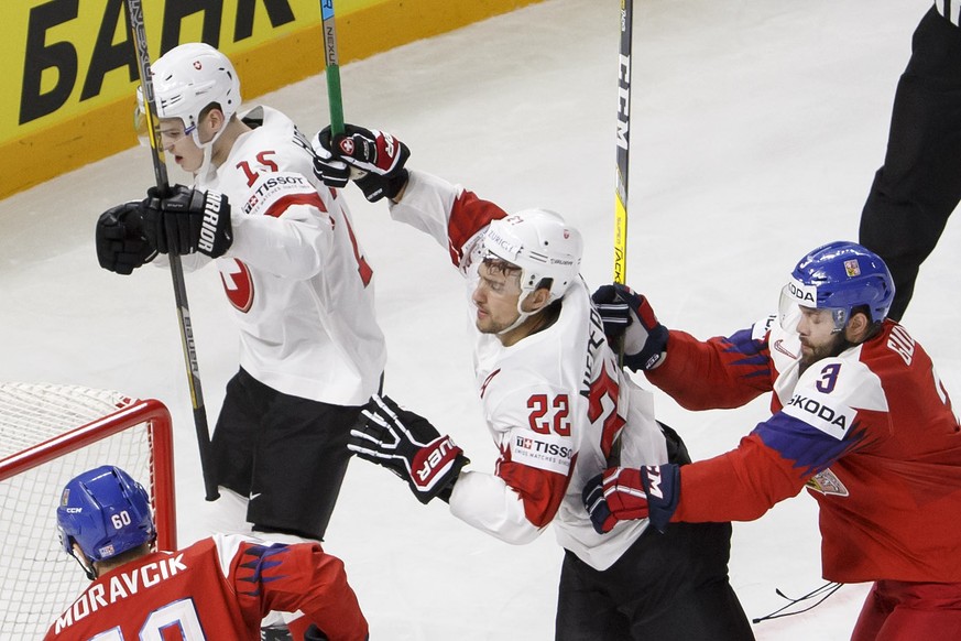 Switzerland&#039;s forward Nino Niederreiter #22 celebrates his goal with teammate forward Gregory Hofmann #15 past Czech Republic&#039;s defender Michal Moravcik, left, and Czech Republic&#039;s defe ...