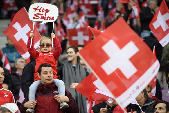 Swiss fans cheer with swiss flags during the 2018 Fifa World Cup Russia group B qualification soccer match between Switzerland and Latvia, at the stade de Geneve stadium, in Geneva, Switzerland, Saturday, March 25, 2017. (KEYSTONE/Laurent Gillieron)