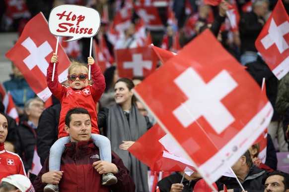 Swiss fans cheer with swiss flags during the 2018 Fifa World Cup Russia group B qualification soccer match between Switzerland and Latvia, at the stade de Geneve stadium, in Geneva, Switzerland, Satur ...