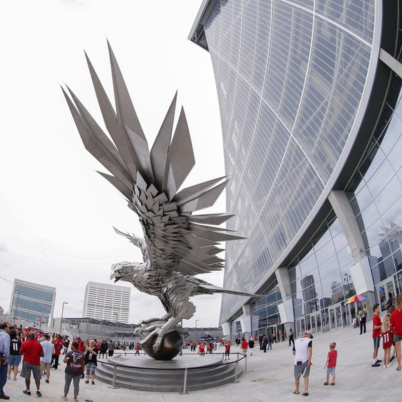 epa06165505 Fans gather around a large falcon statue outside the newly opened Mercedes-Benz Stadium before attending the NFL American preseason football game between the Arizona Cardinals and the Atla ...