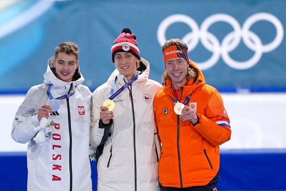 Gold medallist Metodej Jilek of Czechia, center, celebrates on the podium with Vladimir Semirunniy of Poland, left and silver medal, and Jorrit Bergsma of the Netherlands, right and bronze medal, afte ...
