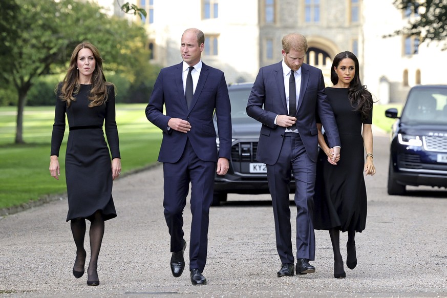 From left, Britain&#039;s Kate, Princess of Wales, Prince William, Prince of Wales, Prince Harry, and Meghan, Duchess of Sussex walk to meet members of the public, at Windsor Castle, following the dea ...