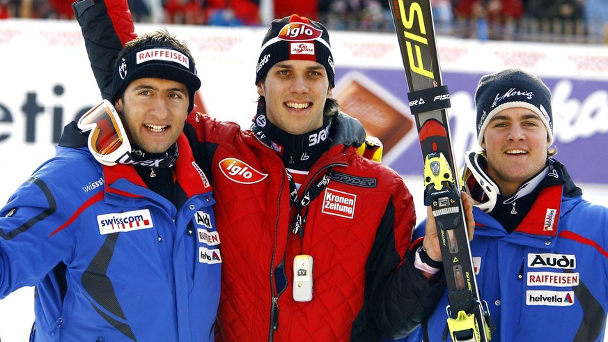 Austria&#039;s Mario Matt, center, winner of the Alpine Ski World Cup men&#039;s super-combi race, celebrates in the finish area with second placed Switzerland&#039;s Marc Berthod, right, and third pl ...