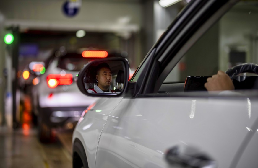 epa08746782 A man drives a car trough production line of Dongfeng Yueda KIA Motors factory in Yancheng, Jiangsu province, China, 15 October 2020. Dongfeng Yueda KIA Motors Plant 3 was put into operati ...