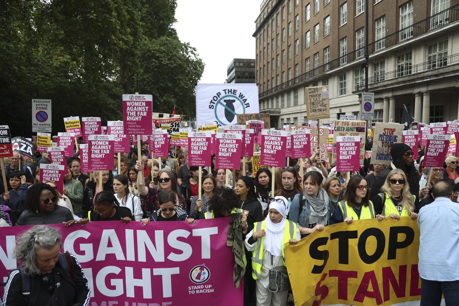 epa12373038 Supporters of &#039;Stand Up to Racism&#039; hold placards ahead of a protest in central London, Britain, 13 September 2025. Two opposing demonstrations are being held simultaneously in Lo ...