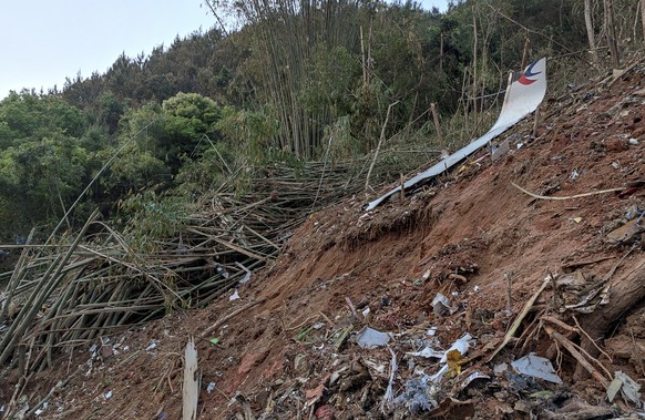 In this photo taken by mobile phone released by Xinhua News Agency, a piece of wreckage of the China Eastern&#039;s flight MU5735 are seen after it crashed on the mountain in Tengxian County, south Ch ...