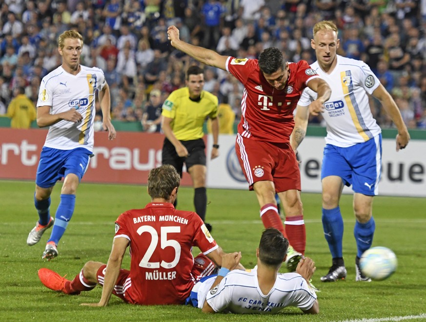 Robert Lewandowski of Bayern Munich, 2nd of right, shoots to score the first goal during the German soccer cup, DFB Pokal, match between third divisioner FC Carl Zeiss Jena and first divisioner Bayern ...