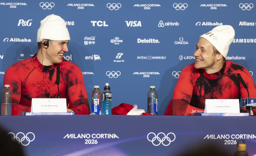 Gold medal winner Franjo von Allmen of Switzerland, left, and bronze medal winner Marco Odermatt of Switzerland react during a press conference after the men's alpine skiing Super-G race at the 2 ...