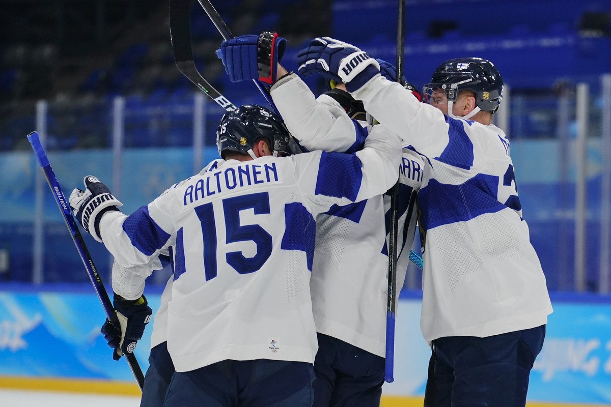 Finland players celebrate after Leo Komarov (71) scored a goal against Latvia during a preliminary round men's hockey game at the 2022 Winter Olympics, Friday, Feb. 11, 2022, in Beijing. (AP Phot ...