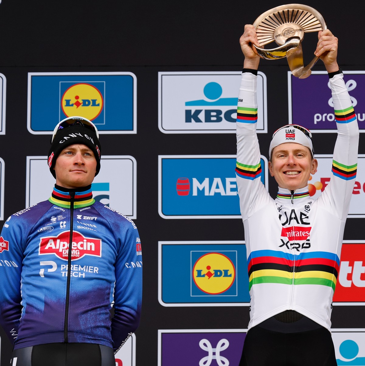 Slovenia's Tadej Pogacar celebrates after winning the Tour of Flanders cycling race, with Netherland's Mathieu Van Der Poel, left, finishing second and Belgium's Remco Evenpoel third in ...
