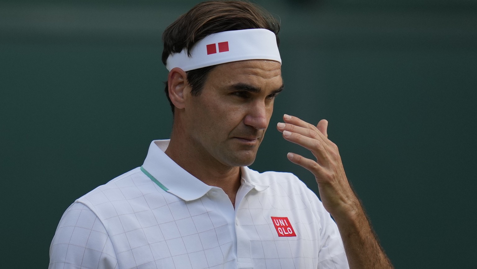 Switzerland&#039;s Roger Federer reacts during the men&#039;s singles quarterfinals match against Poland&#039;s Hubert Hurkacz on day nine of the Wimbledon Tennis Championships in London, Wednesday, J ...