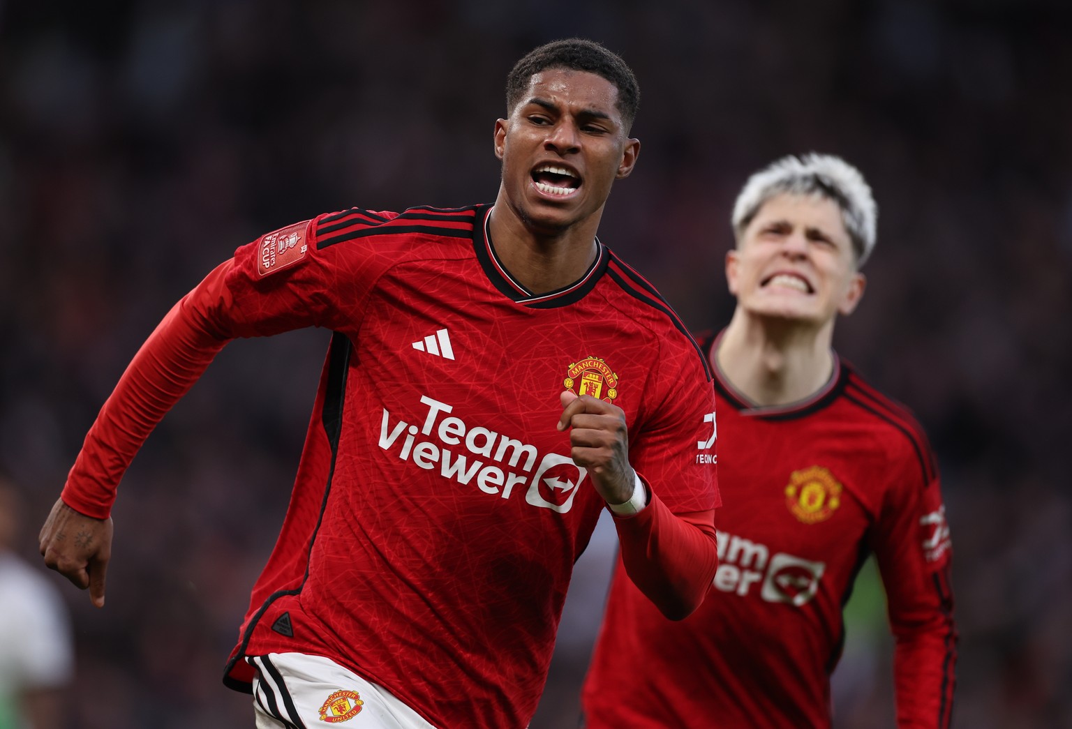epa11226504 Marcus Rashford of Manchester United (L) celebrates scoring the 3-3 goal during the FA Cup quarter-final soccer match between Manchester United and Liverpool in Manchester, Britain, 17 Mar ...