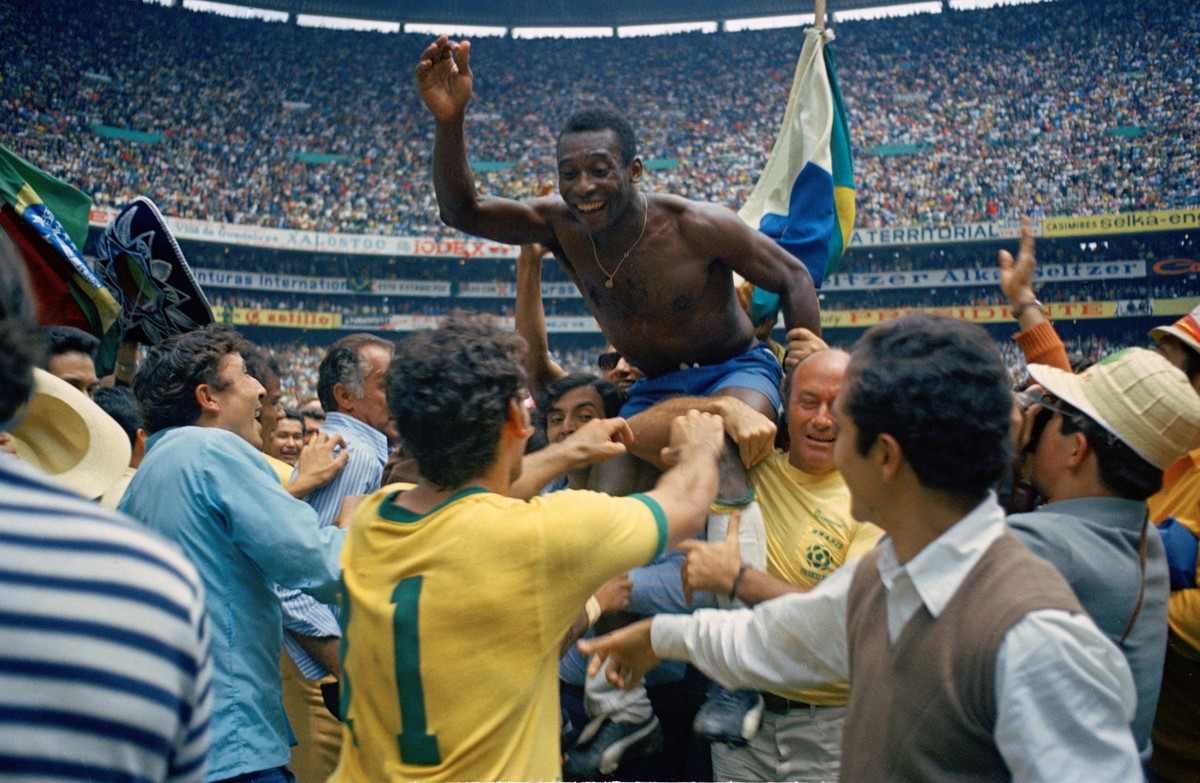 FILE - In this June 21, 1970 file photo, Brazil's Pele, centre is hoisted on the shoulders of his teammates after Brazil won the World Cup soccer final against Italy, 4-1, in Mexico City's E ...