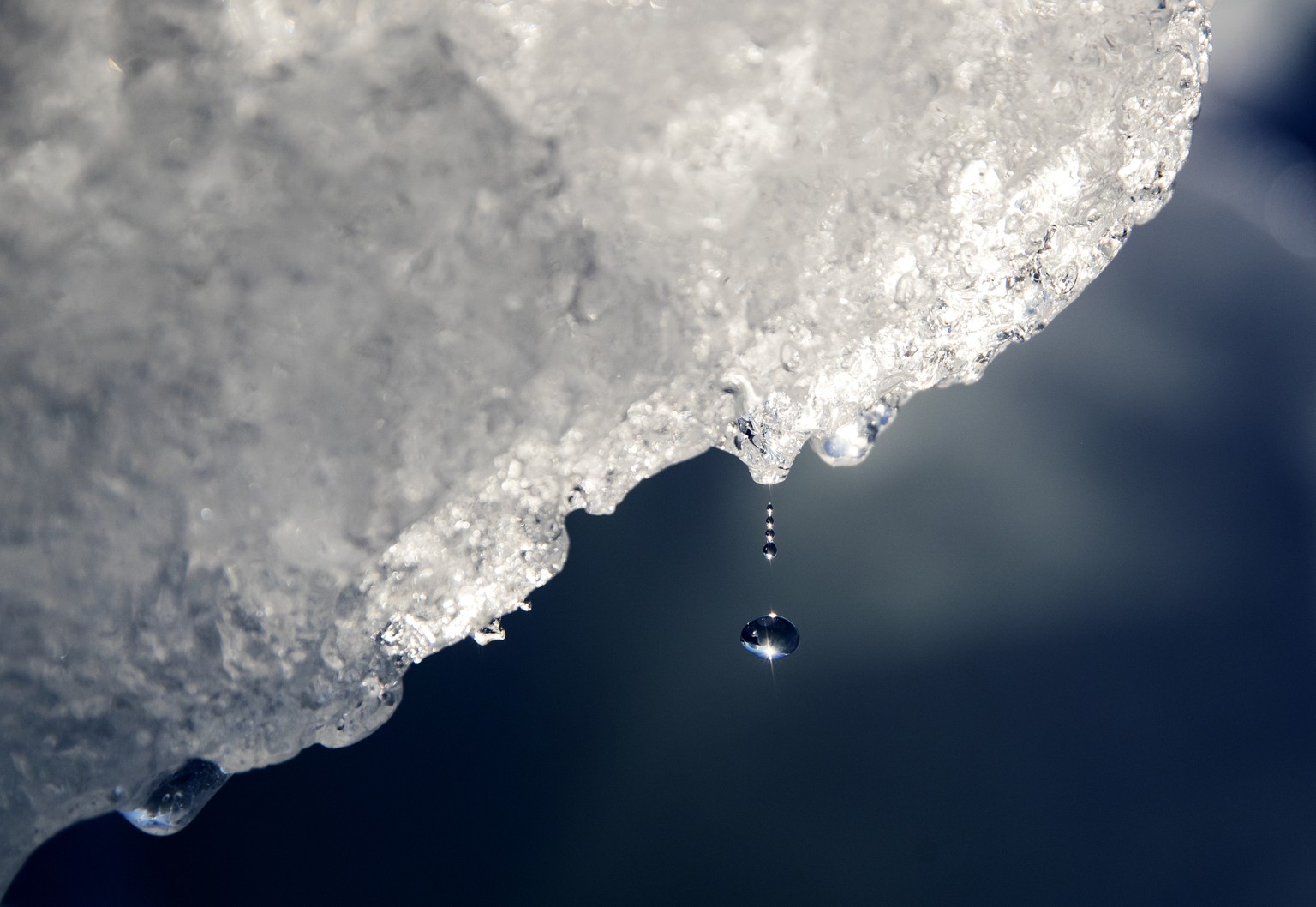 FILE - A drop of water falls off an iceberg melting in the Nuup Kangerlua Fjord near Nuuk in southwestern Greenland, Tuesday, Aug. 1, 2017. According to a report by the U.S. National Oceanic and Atmos ...