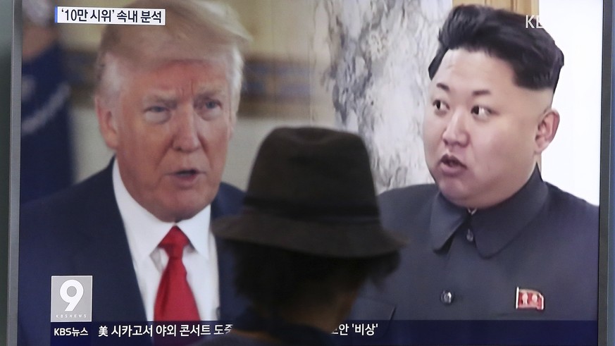 FILE - In this Aug. 10, 2017, file photo, a man watches a television screen showing U.S. President Donald Trump and North Korean leader Kim Jong Un during a news program at the Seoul Train Station in  ...