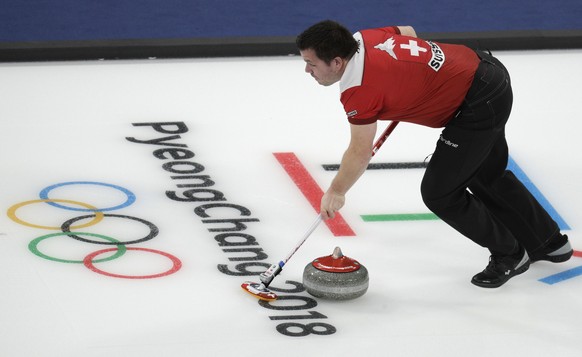 Switzerland&#039;s Martin Rios sweeps ice during their mixed doubles curling match against United States at the 2018 Winter Olympics in Gangneung, South Korea, Saturday, Feb. 10, 2018. (AP Photo/Aaron ...