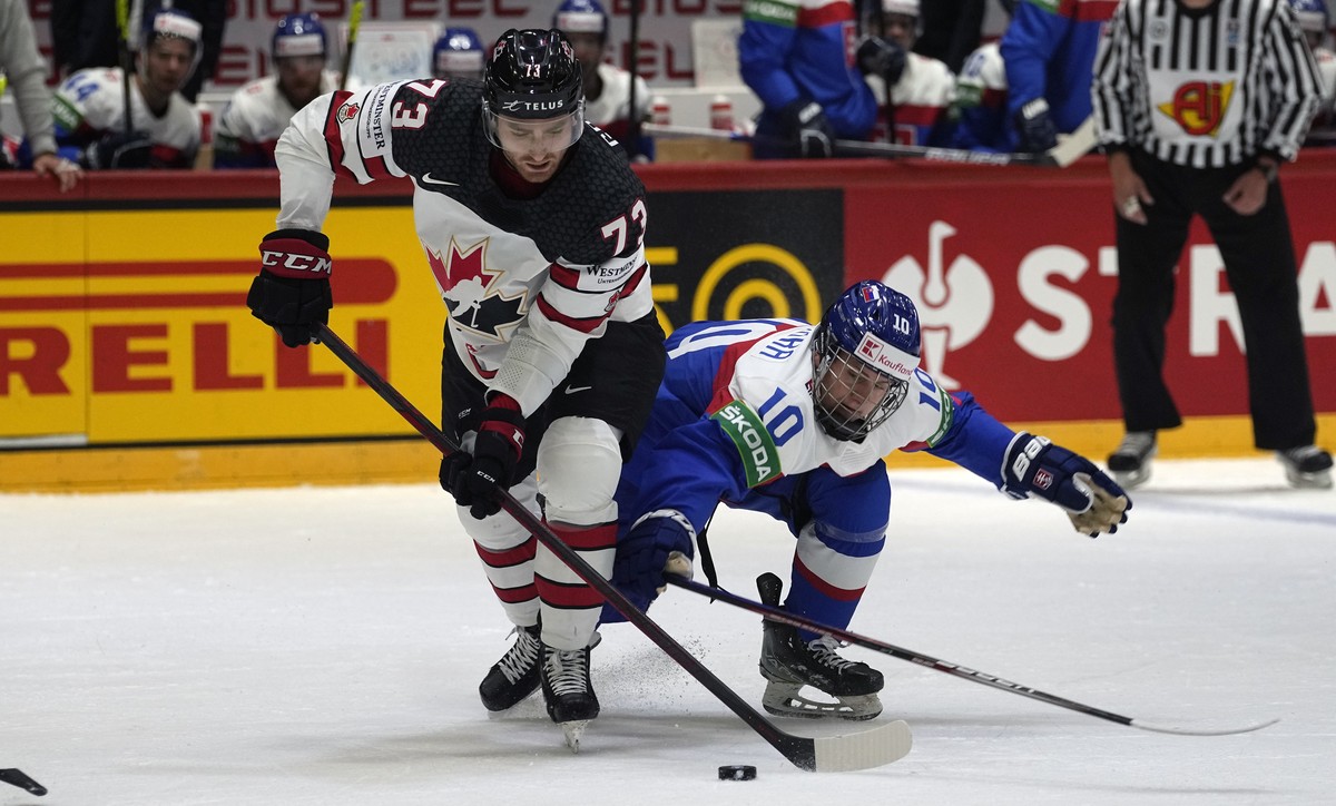 Noah Gregor of Canada, left, is challenged by Slovakia's Adam Sykora during the group A Hockey World Championship match between Slovakia and Canada in Helsinki, Finland, Monday May 16, 2022. (AP  ...