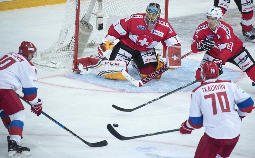 epa06322870 Jonas Hiller (2L) and Felicien Du Bois of Switzerland in action against Sergei Mozyakin (L) and Vladimir Tkachyov ((R) of Russia during the 2017 Karjala Cup ice hockey match between Switze ...