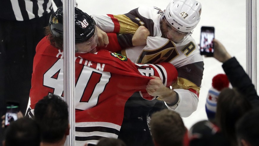 Chicago Blackhawks right wing John Hayden, left, and Vegas Golden Knights defenseman Luca Sbisa fight during the second period of an NHL hockey game Friday, Jan. 5, 2018, in Chicago. (AP Photo/Nam Y.  ...