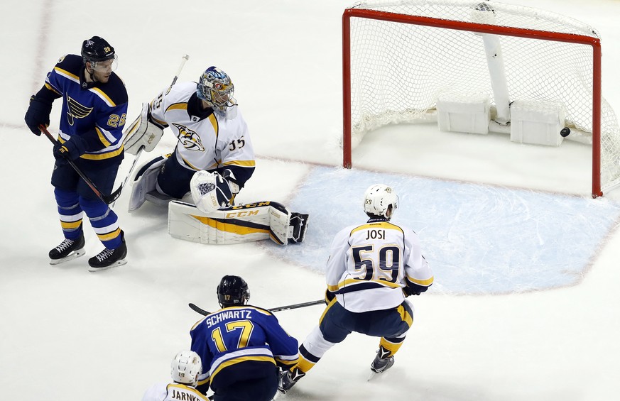 St. Louis Blues center Paul Stastny (26) and Nashville Predators goalie Pekka Rinne (35) look back as a shot by Blues right wing Vladimir Tarasenko, not shown, gets past Rinne for a goal during the fi ...