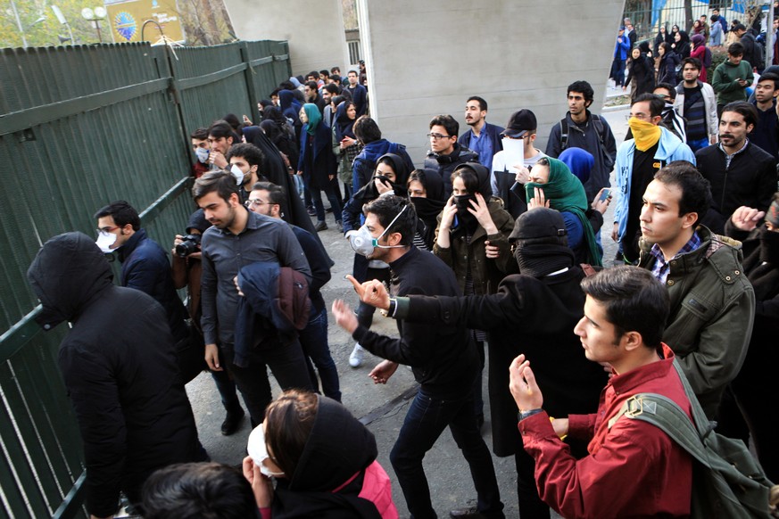 epa06410378 Iranian students clash with riot police during an anti-government protest around the University of Tehran, Iran, 30 December 2017. Media reported that illegal protest against the governmen ...