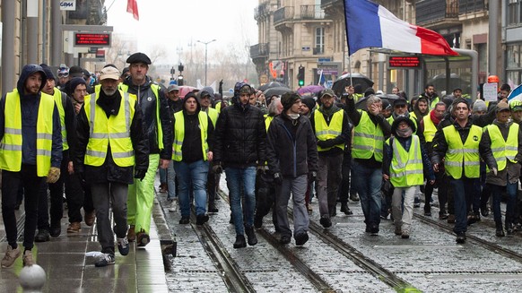 epa07233471 Yellow Vest protesters stand by the Place de la Bourse during a demonstration in Bordeaux, France, 15 December 2018. The so-called &#039;gilets jaunes&#039; (yellow vests) is a protest mov ...