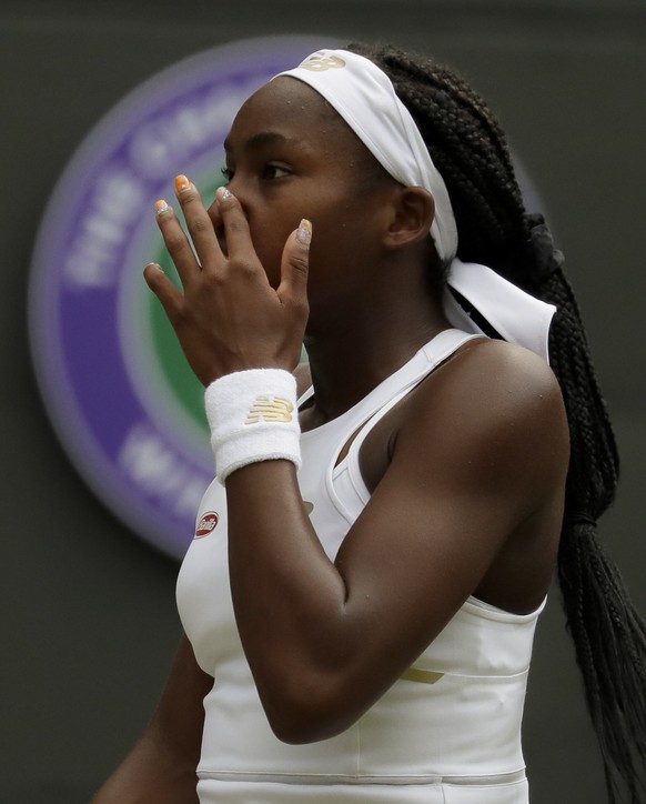 United States' Cori "Coco" Gauff pauses during a women's singles match against Romania's Simona Halep on day seven of the Wimbledon Tennis Championships in London, Monday, Jul ...