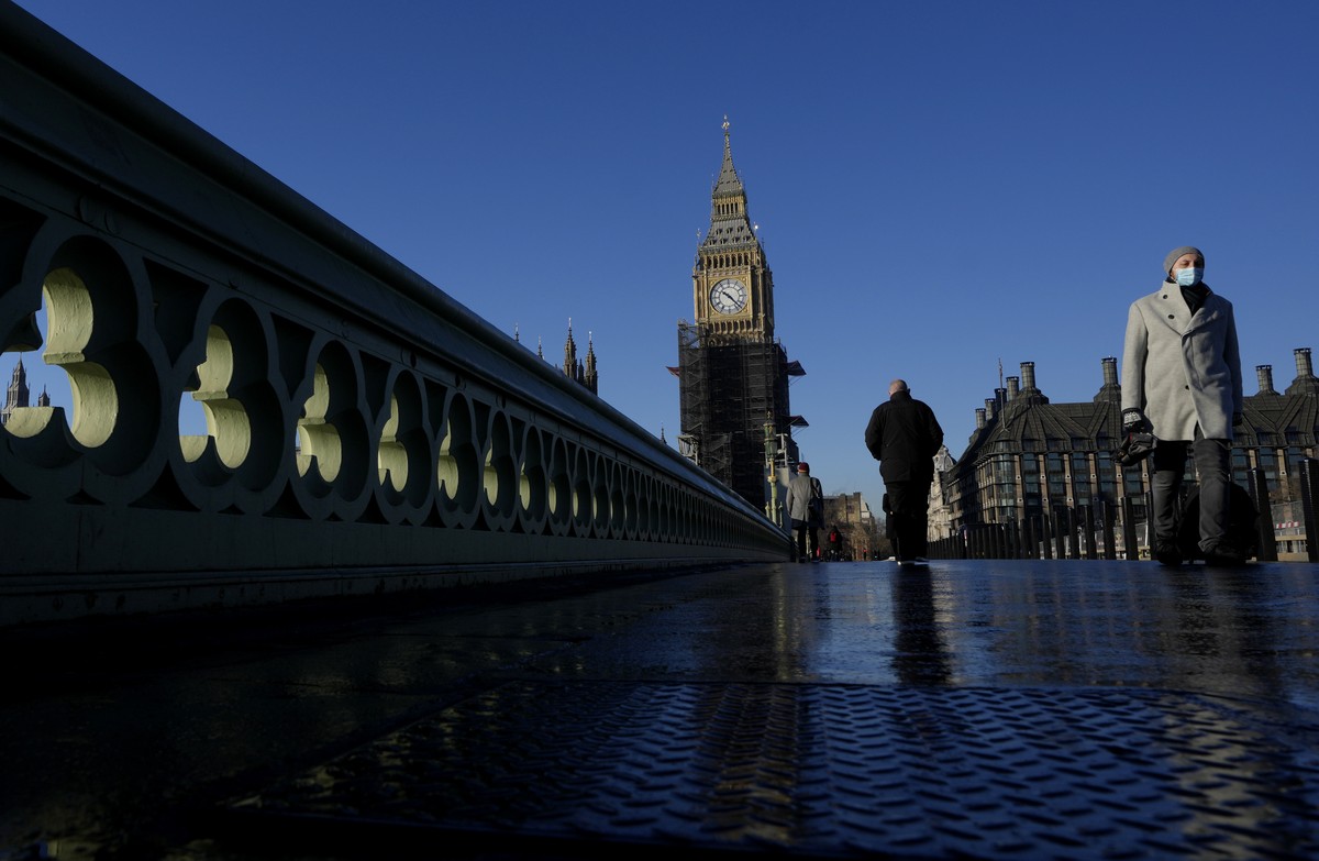 Pedestrian walk over Westminster Bridge near Parliament in London, Thursday, Jan. 13, 2022. Senior British government ministers have expressed support for Conservative Prime Minister Boris Johnson and ...