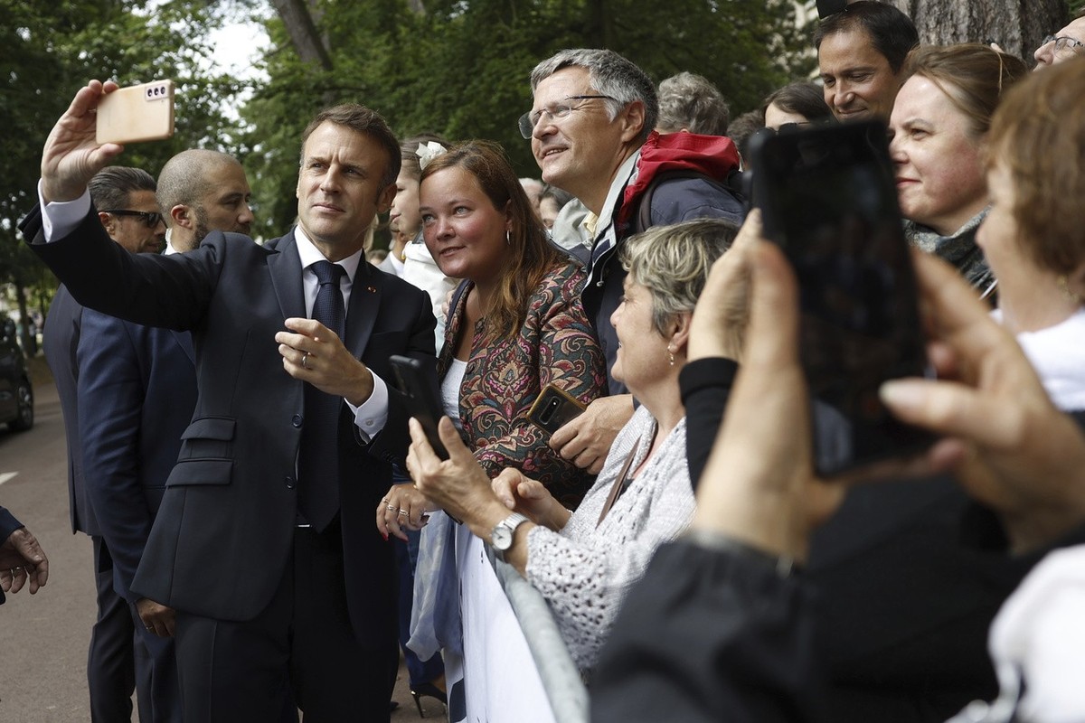 French President Emmanuel Macron makes a selfie for supporters after voting for the second round of the legislative elections in Le Touquet-Paris-Plage, northern France, Sunday July 7 2024. Voting has ...