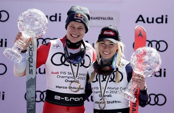 epa10532055 Marco Odermatt (L) of Switzerland and Mikaela Shiffrin of US pose with their overall World Cup trophies during the award ceremony at the FIS Alpine Skiing World Cup finals in the skiing re ...