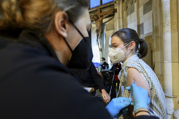epa09592249 A woman receives a booster dose of Covid-19 vaccine inside the Saint Stephen&#039;s Cathedral in Vienna, Austria, 19 November 2021. Austrian Chancellor Alexander Schallenberg announced a m ...
