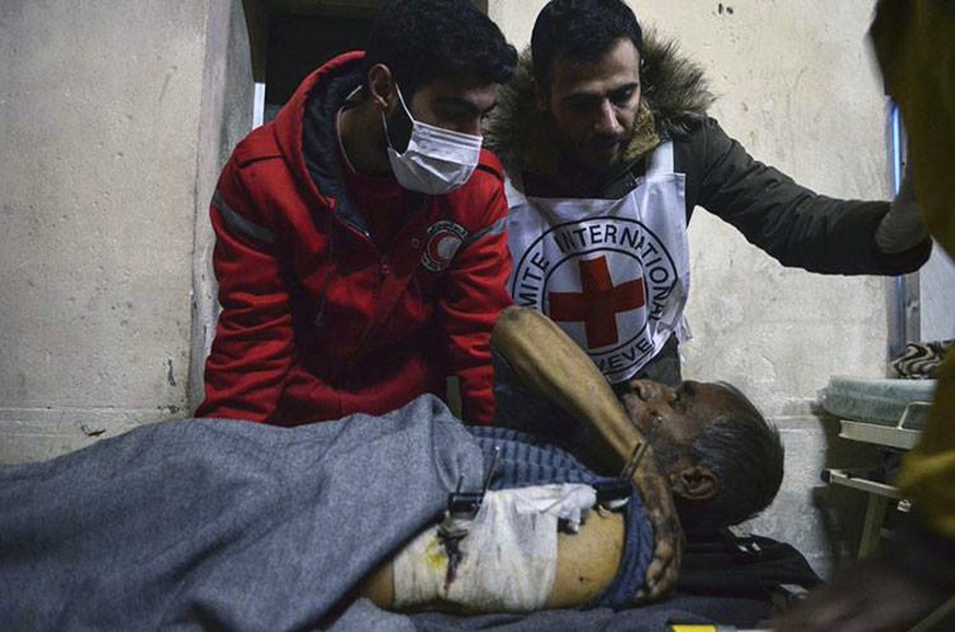 This Wednesday, Dec. 7, 2016 photo, released by the International Committee for the Red Cross, shows members of the Syrian Arab Red Crescent laying a patient on stretcher after taking him out of a med ...