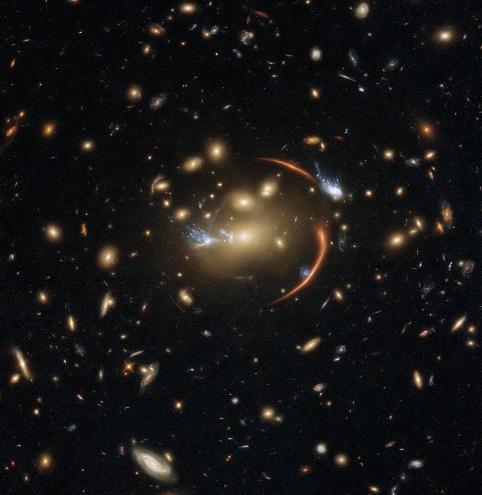 The centre of this image from the NASA/ESA Hubble Space Telescope is framed by the tell-tale arcs that result from strong gravitational lensing, a striking astronomical phenomenon which can warp, magn ...
