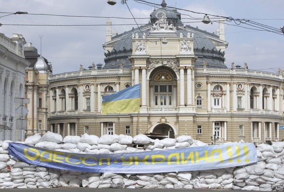 epaselect epa09833829 The Odessa National Academic Theatre of Opera and Ballet and one of the city&#039;s symbols behind a heavy barricade with a placard reading &#039;Odesa is Ukraine!&#039;, at the  ...
